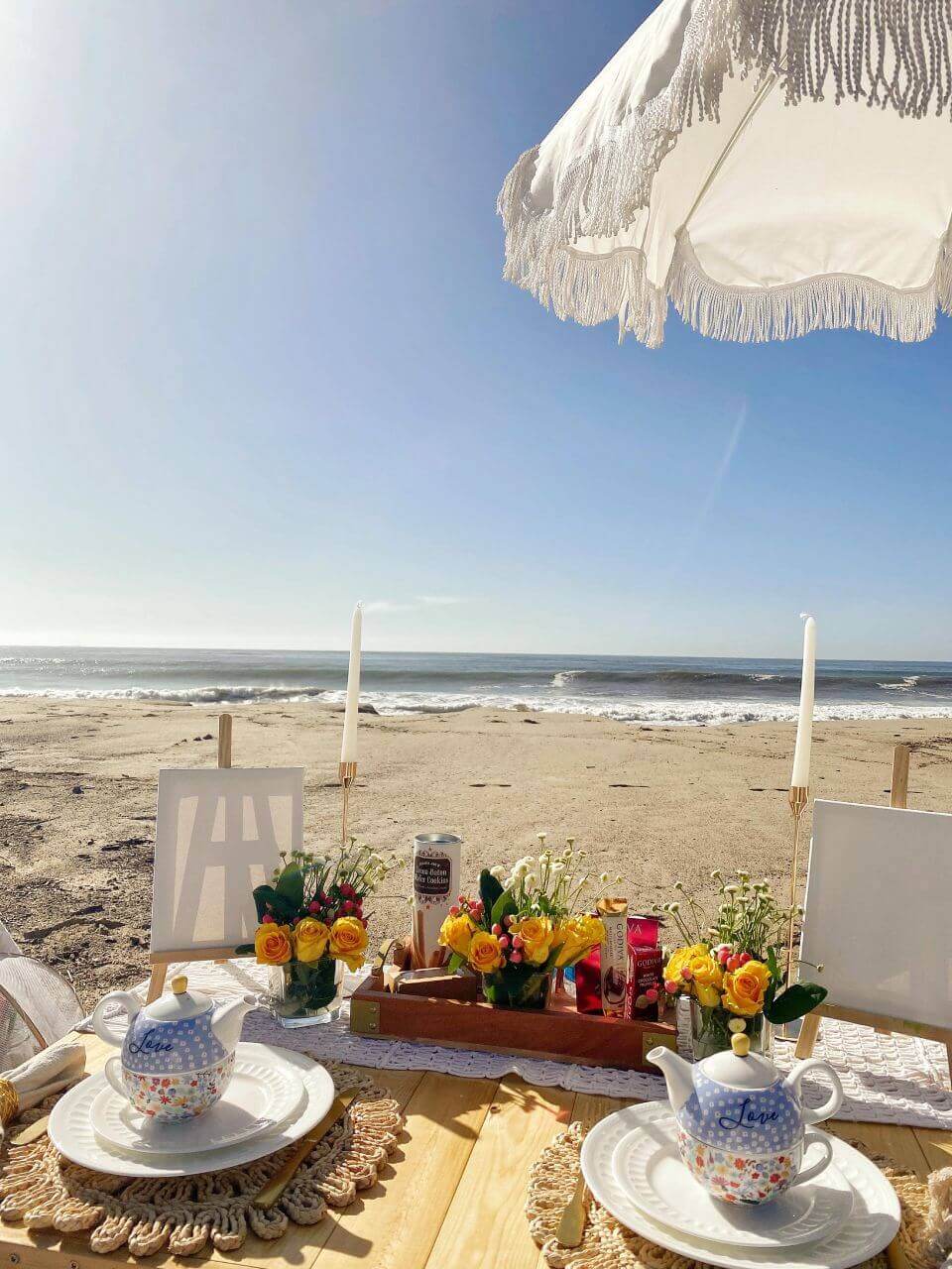 picnic and paint setup on the beach